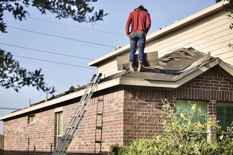 Professional roofer working on a residential roof in South Riding